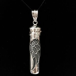 A silver necklace with an angel wing on it.