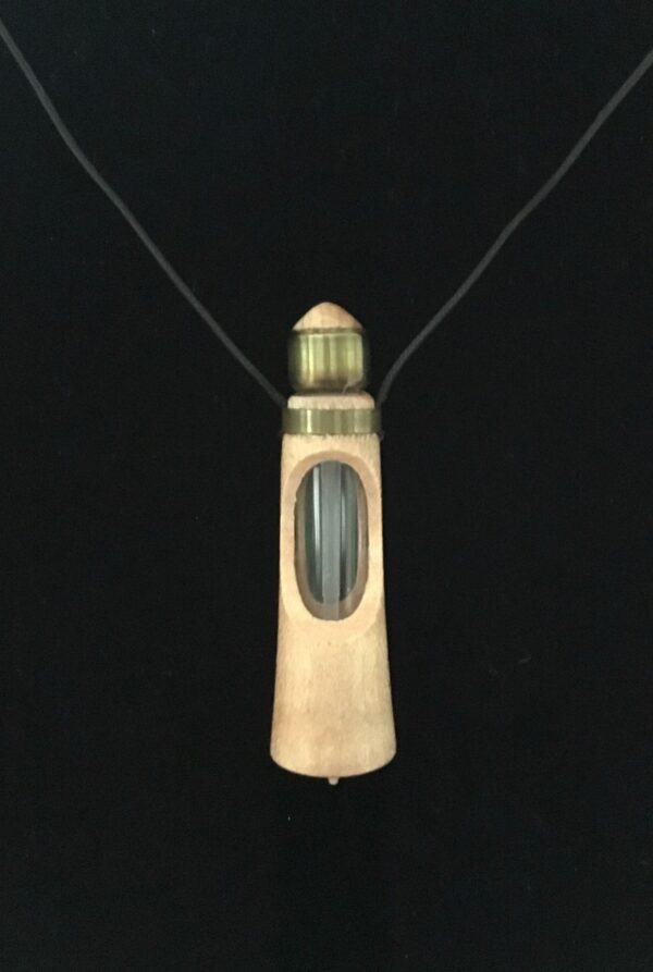 A necklace with a bottle of liquid on it