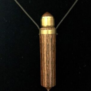 A wooden necklace with gold trim and a string.