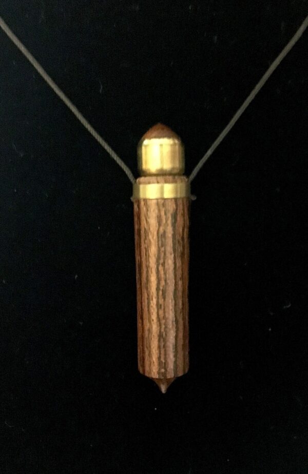 A wooden necklace with gold trim and a string.