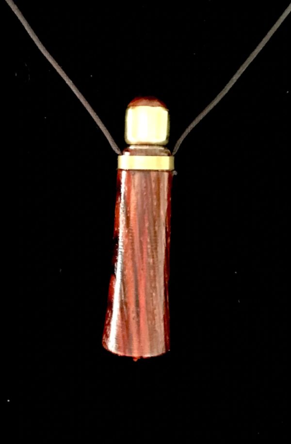 A wooden necklace with a gold top.